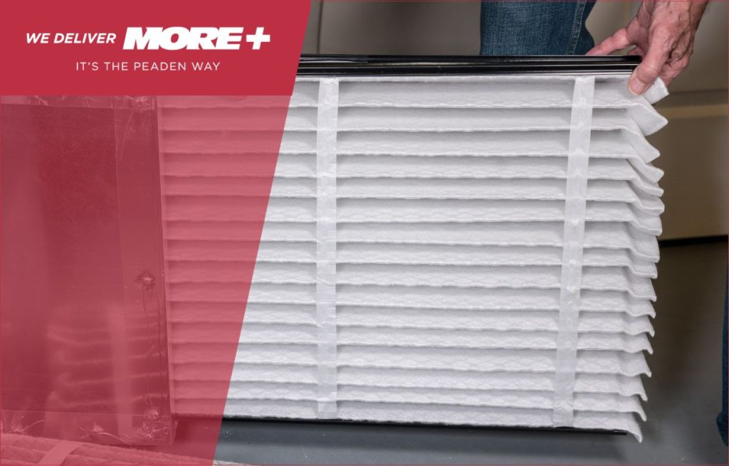 A Peaden HVAC tech changing an air filter