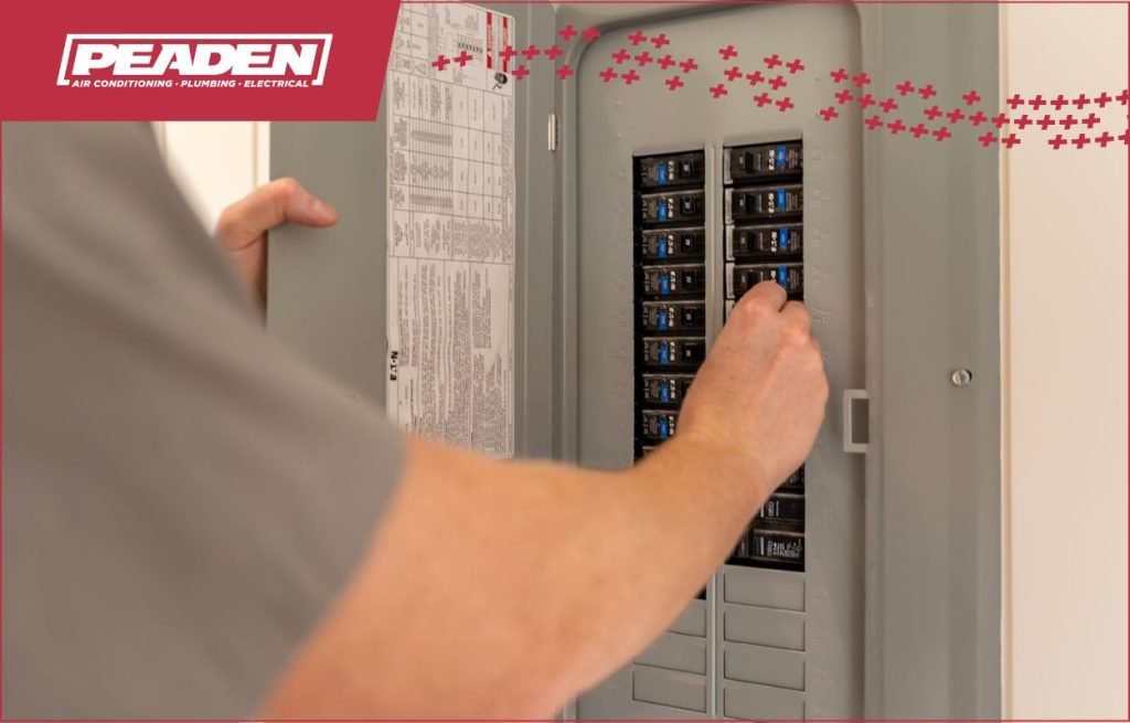 A Peaden Electrician servicing a electrical panel