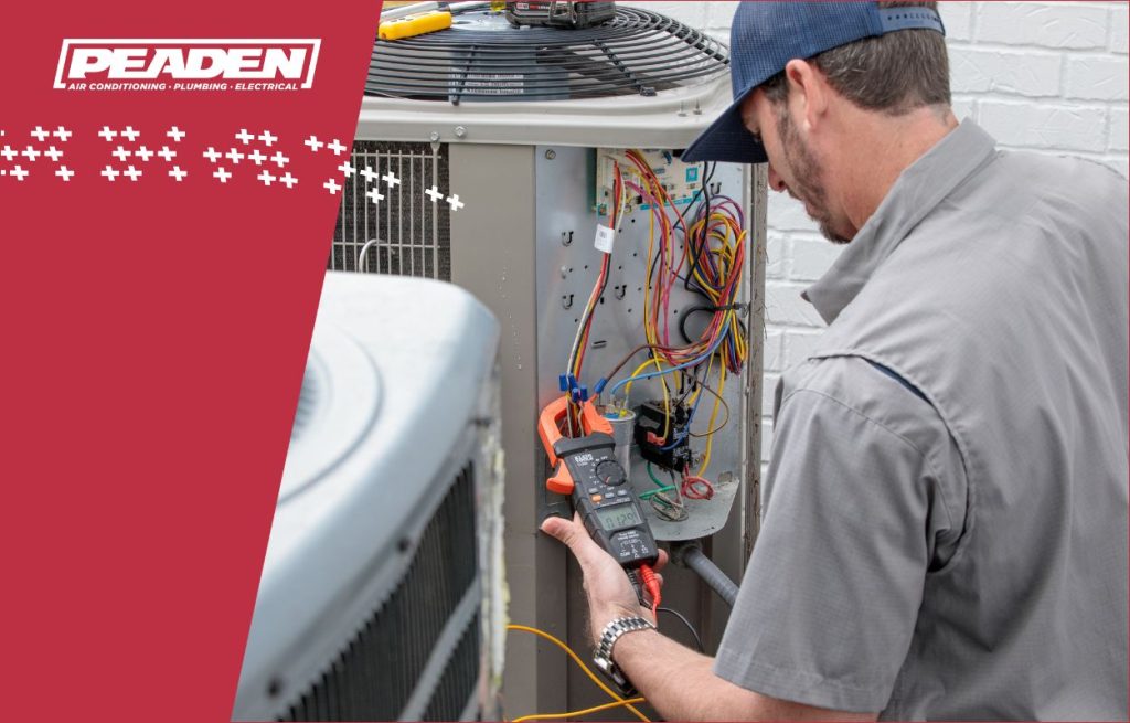 A Peaden HVAC tech working on a AC unit.