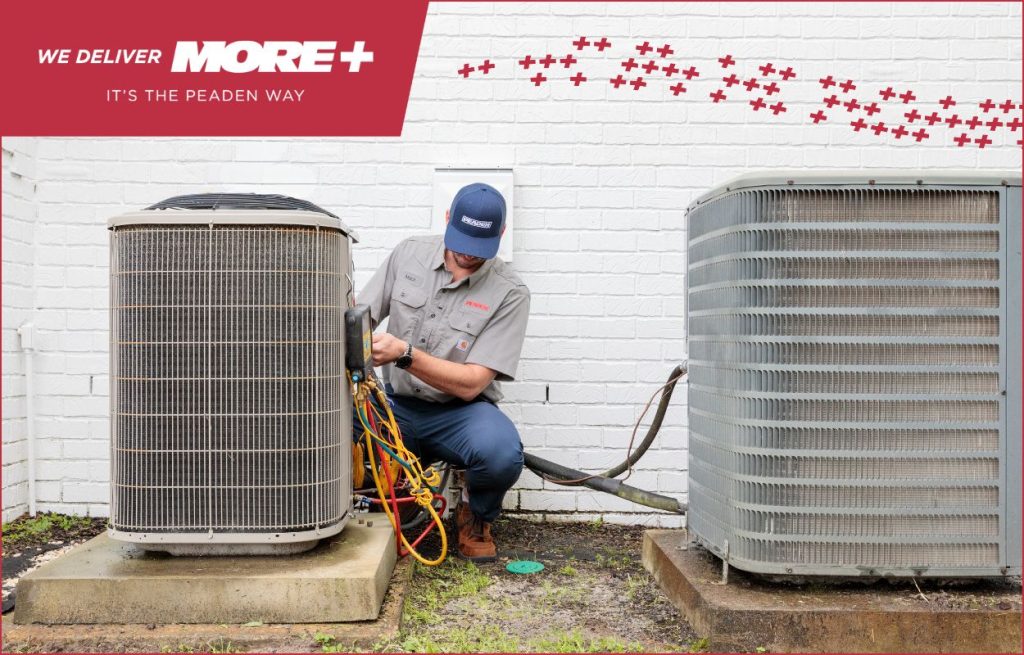 A Peaden HVAC tech doing summer maintenance on an AC unit.