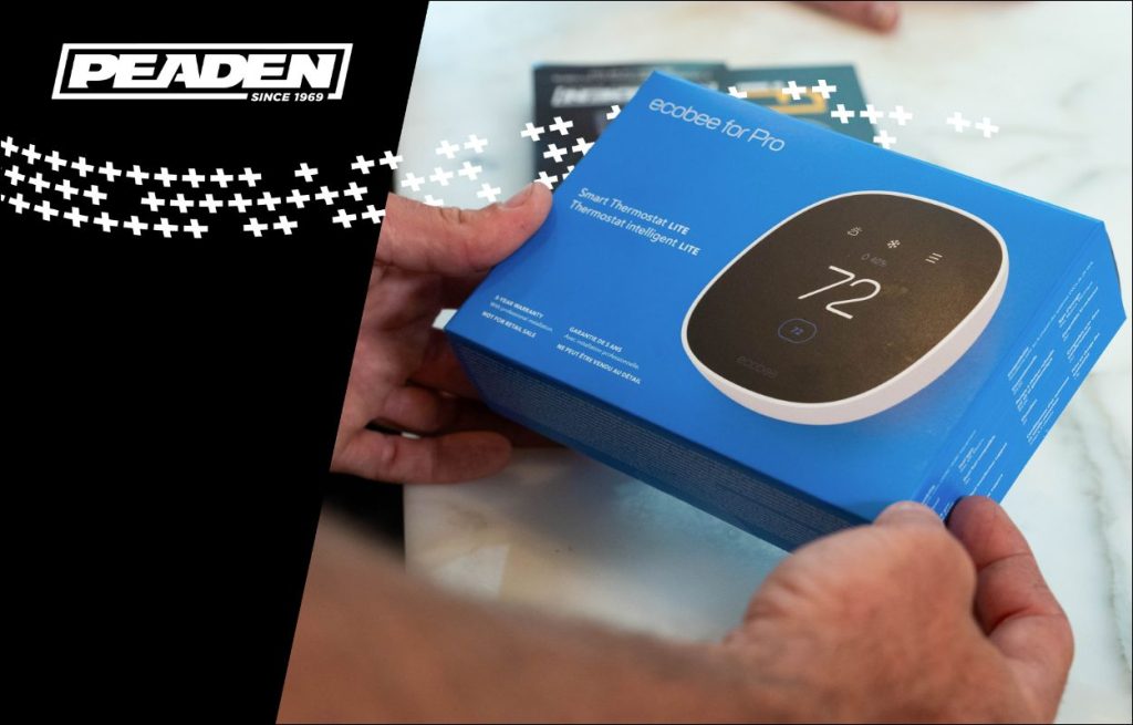 A Peaden HVAC tech showing a smart thermometer