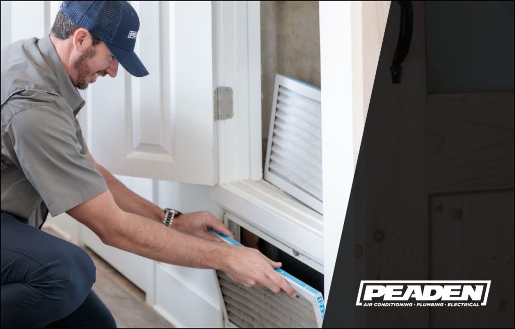 A Peaden HVAC tech changing an air filter