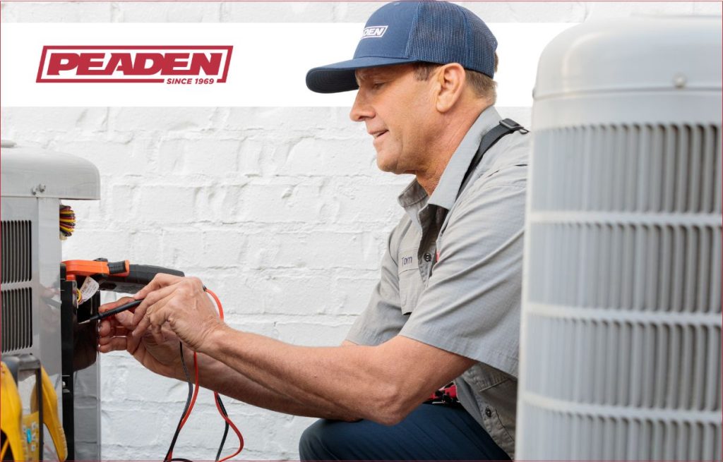 A Peaden HVAC tech working on an ac unit