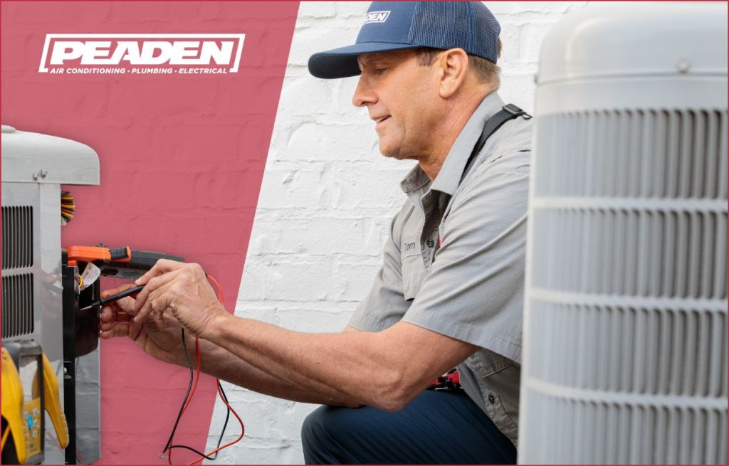 A Peaden HVAC tech working on a AC condenser unit.
