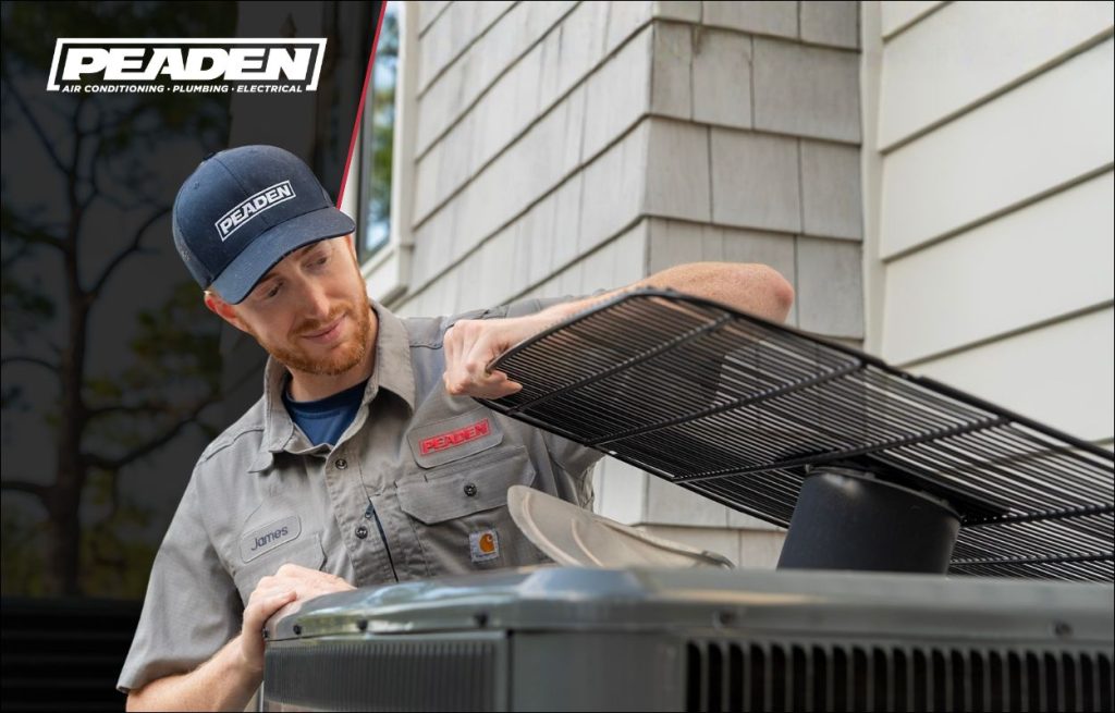 A Peaden HVAC tech working on a heat pump.