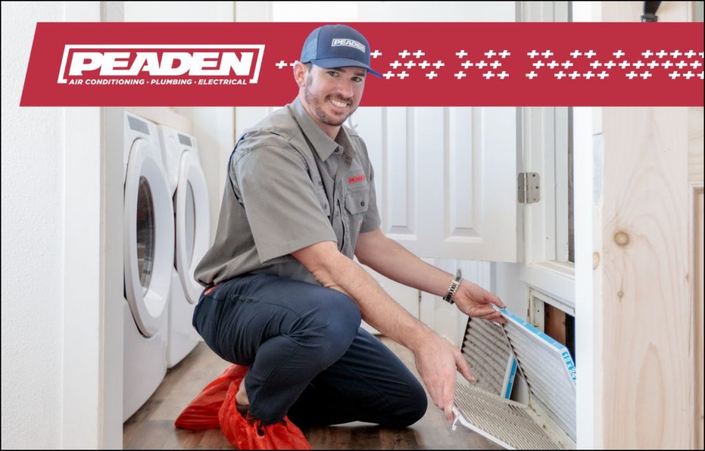 A Peaden HVAC tech changing an air filter