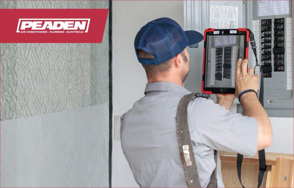 A Peaden Electrician working on a electrical box.