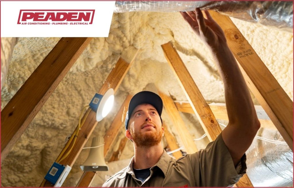 A Peaden HVAC tech inspecting ductwork
