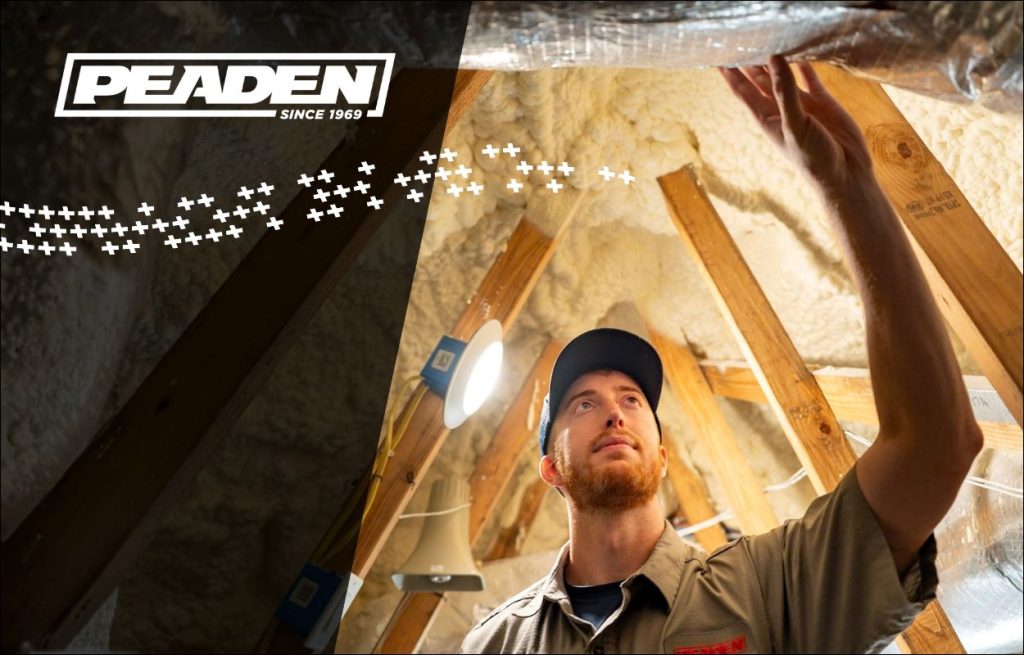A Peaden HVAC tech working on ducts in the attic.