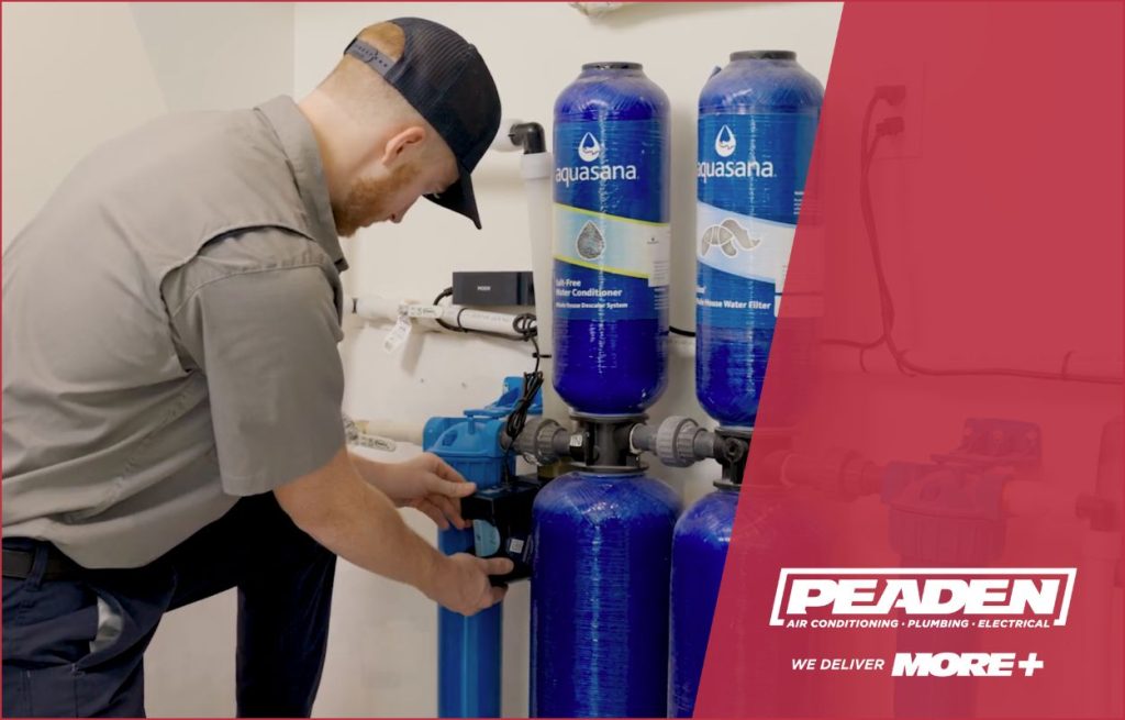 A Peaden plumber installing a Smart Leak Protection sensor from Moen.