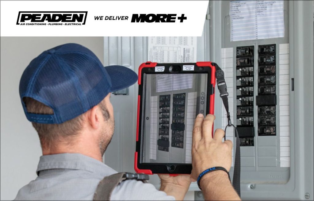 A Peaden Electrician working on a surge protector