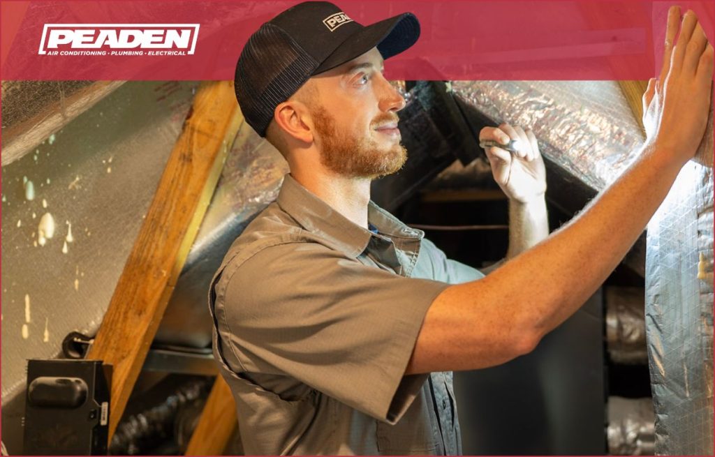 A Peaden HVAC tech checking an air handler