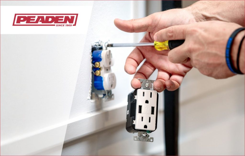 A Peaden Electrician working on a outlet