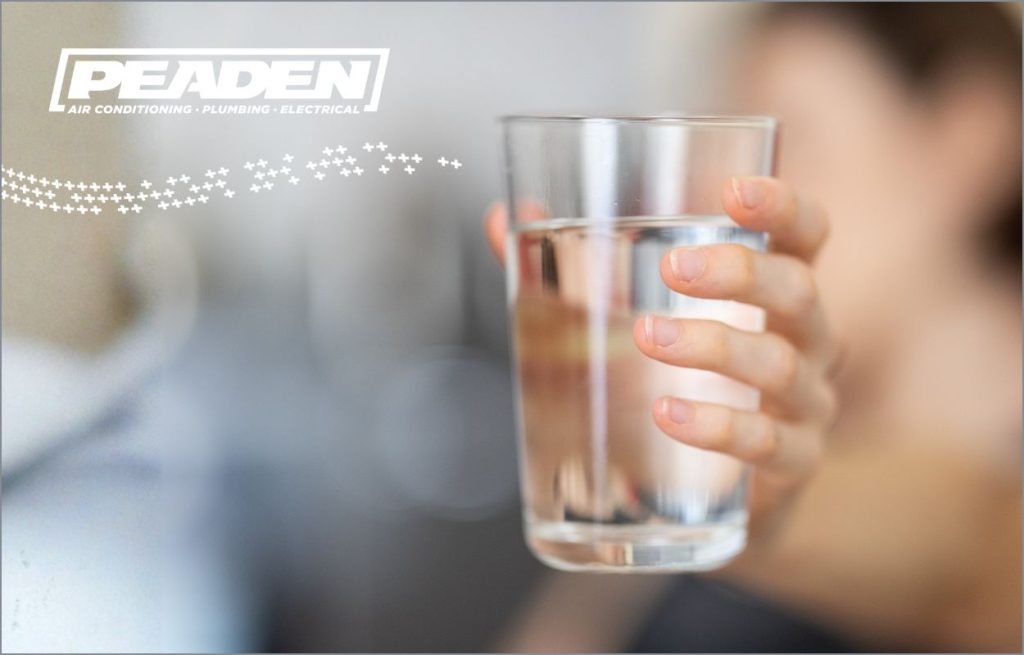 A homeowner holding a clean glass of water.