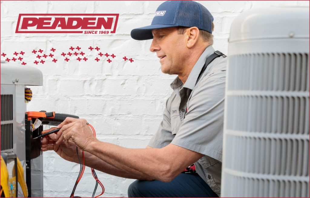 A Peaden HVAC tech working on a AC unit.