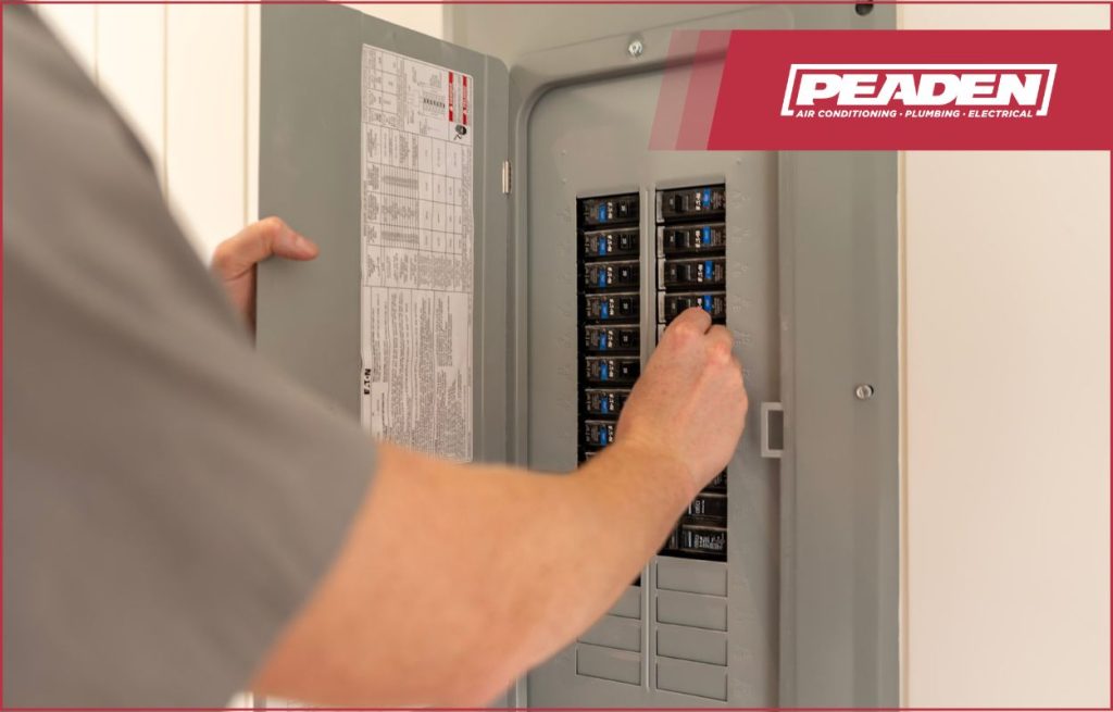 A Peaden Electrician working on a surge protector