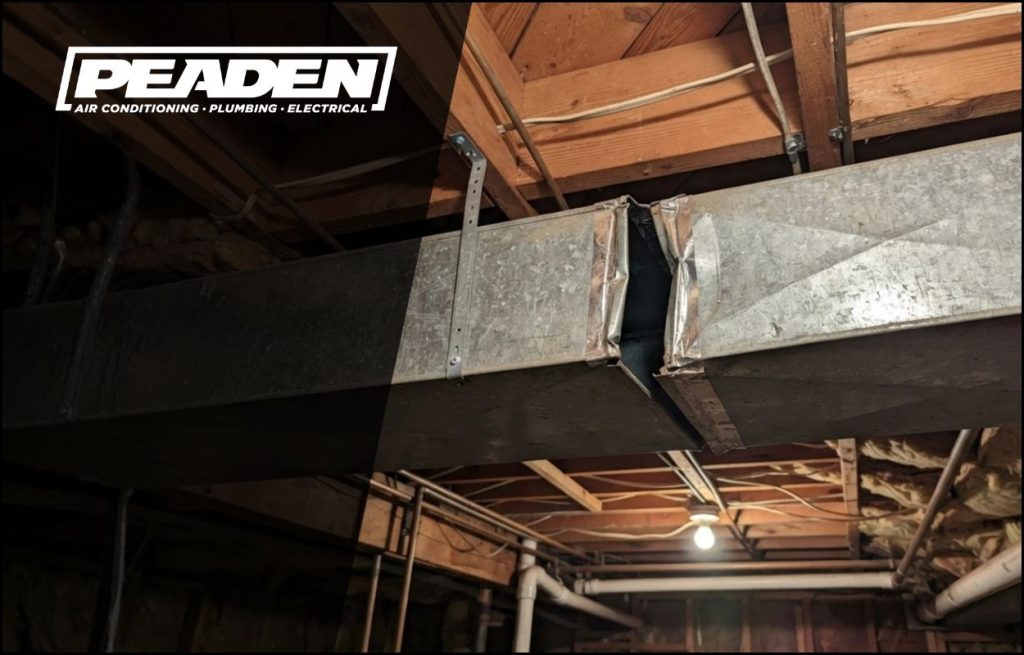 Ductwork in the basement with a gap between the seams leaking air
