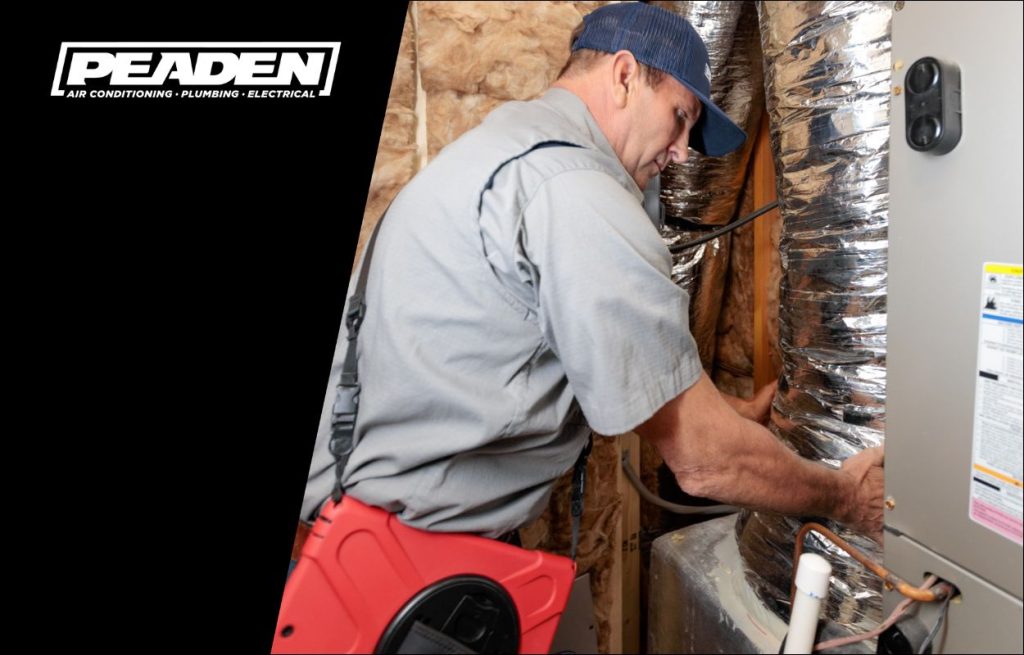 A Peaden HVAC tech working on a air handler