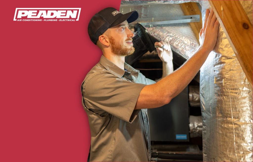 A Peaden HVAC tech working on duct work