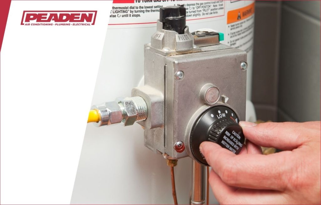 A Peaden plumber checking a water heater.