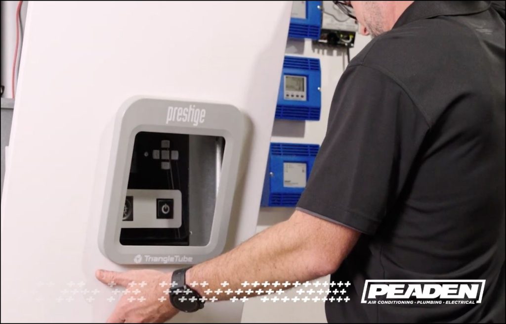 A Peaden plumber installing a tankless water heater.