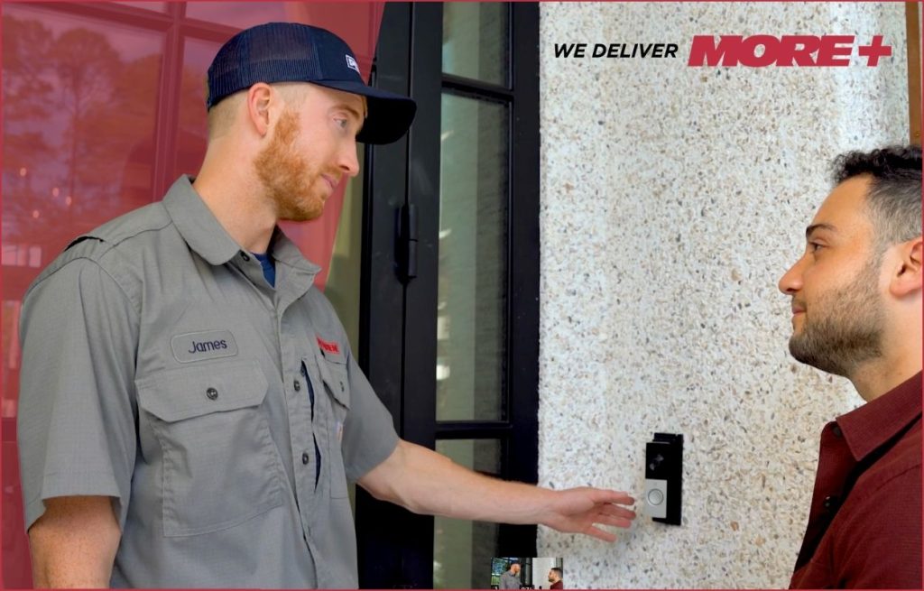 A Peaden Electrician showing a homeowner his new doorbell camera.