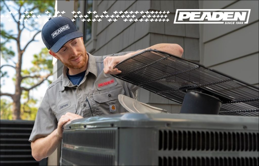 A Peaden HVAC tech working on an AC condenser unit.