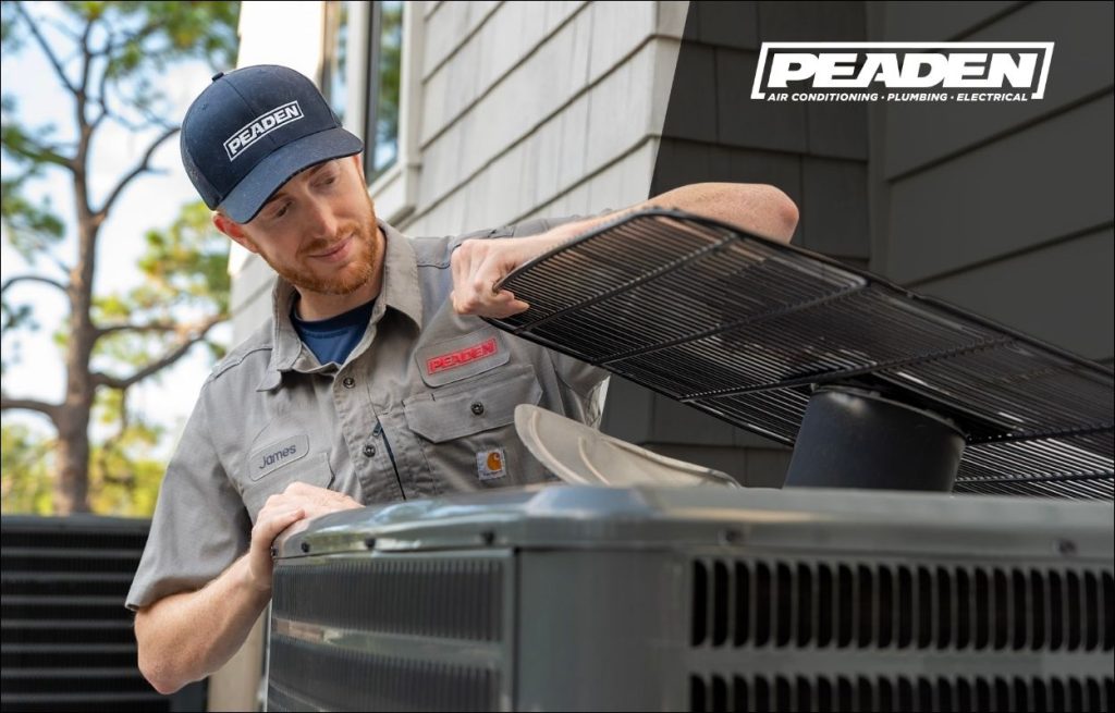 A Peaden HVAC tech working on a AC unit.