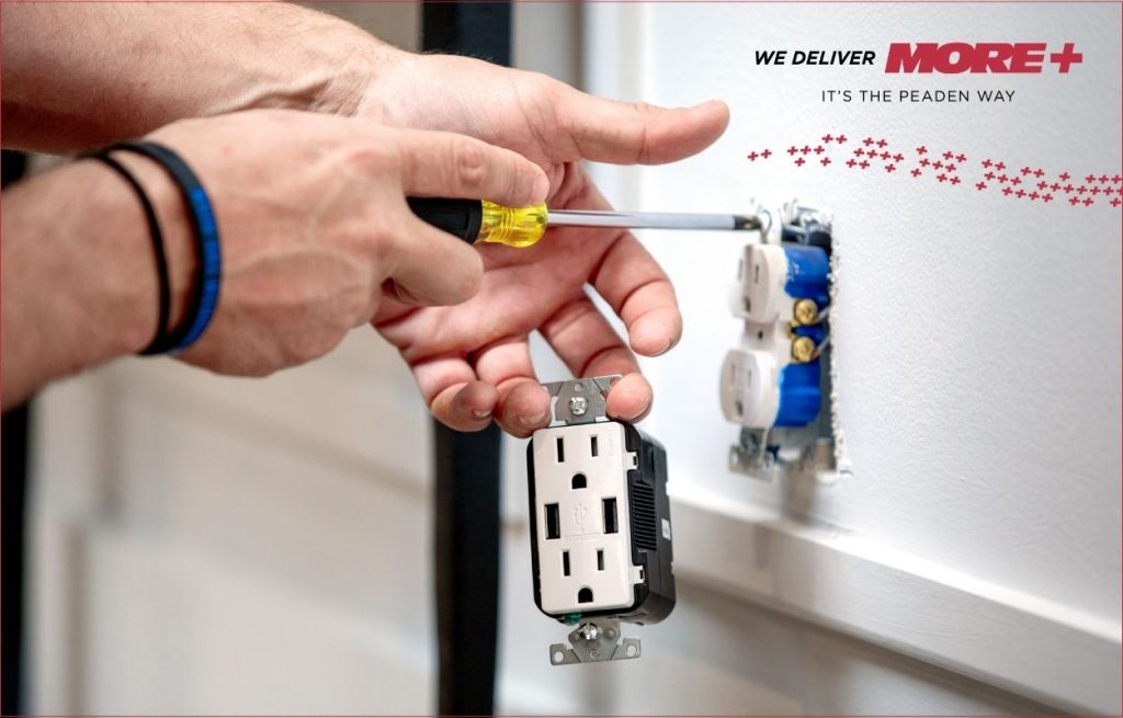 A Peaden Electrician working on an electrical outlet
