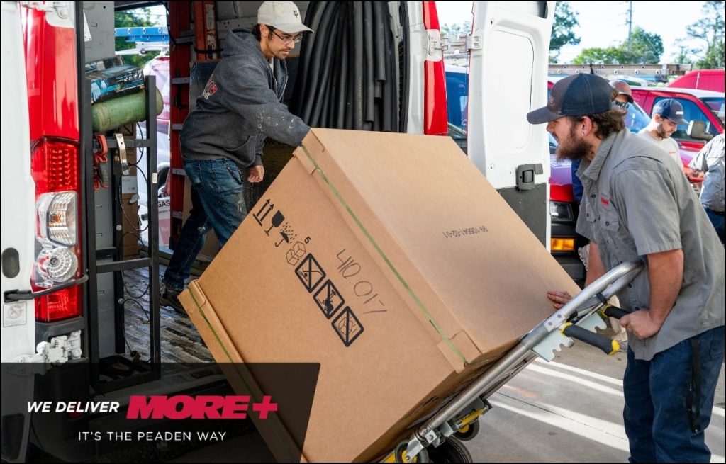 A Peaden HVAC techs delivering a new AC unit.