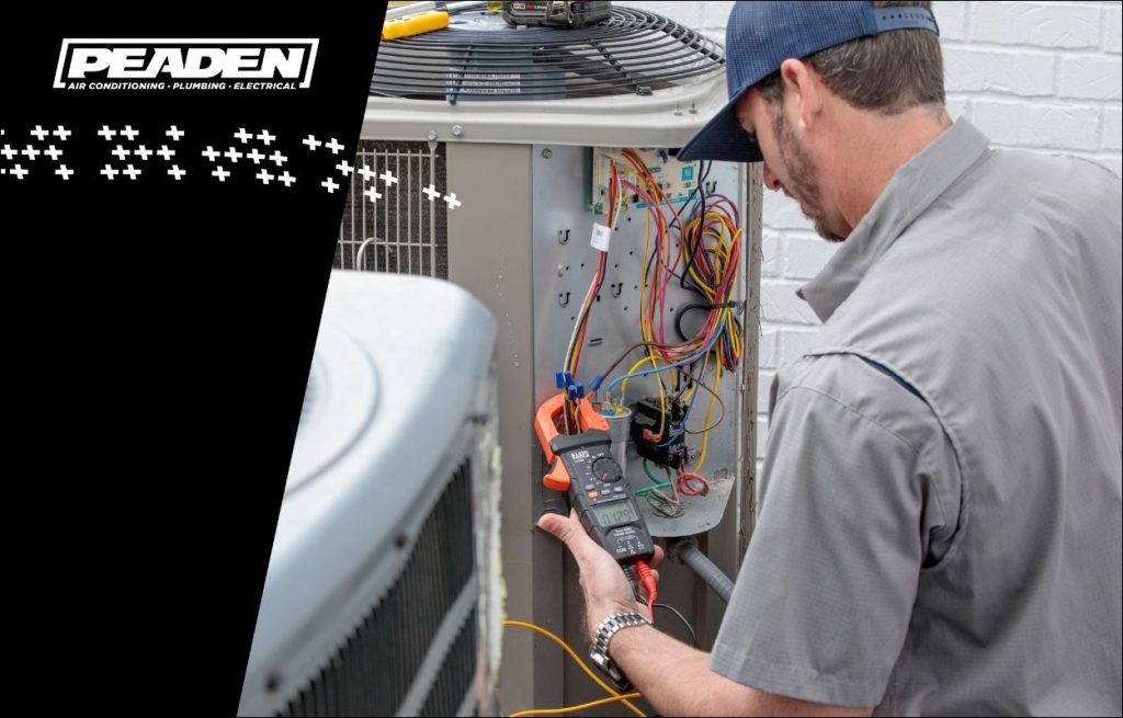 A Peaden HVAC tech working on an AC Unit.