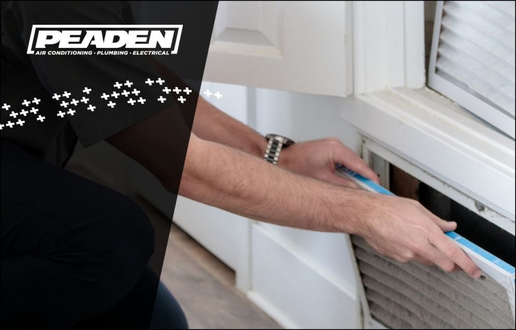 A Peaden HVAC tech changing an air filter