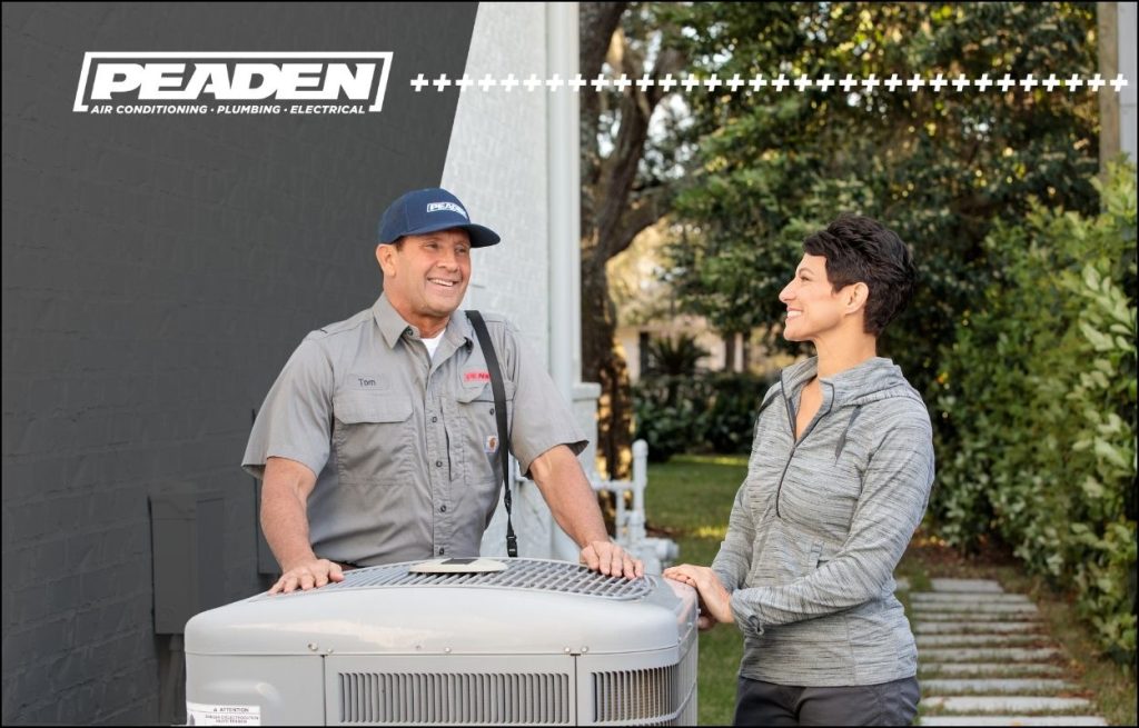 A Peaden HVAC tech discussing AC maintenance with homeowners.