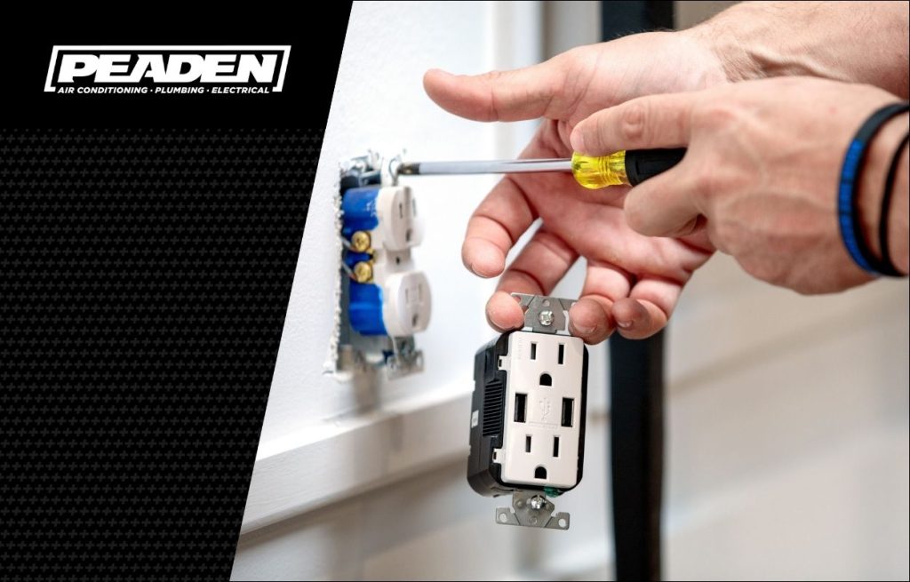 A Peaden Electrician switching out an outlet.