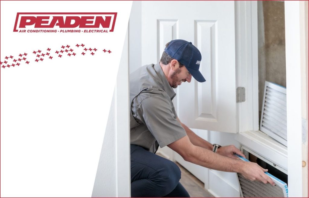 A Peaden HVAC tech changing an air filter
