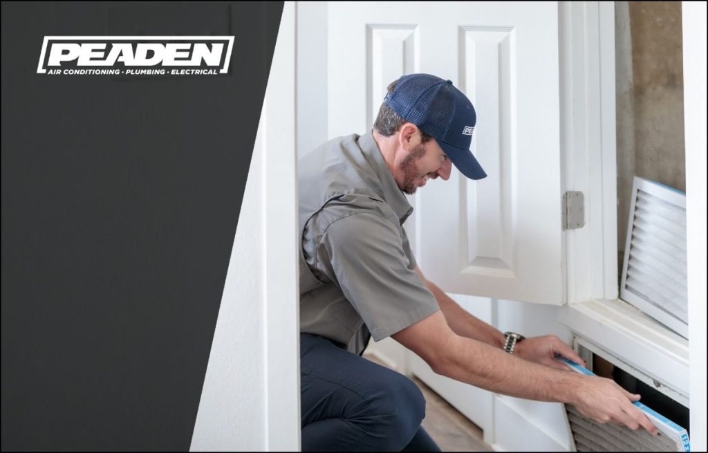 A Peaden HVAC tech changing an air filter