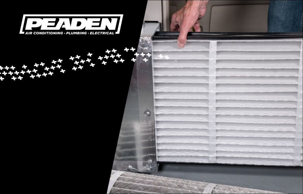 A Peaden HVAC tech changing an air filter