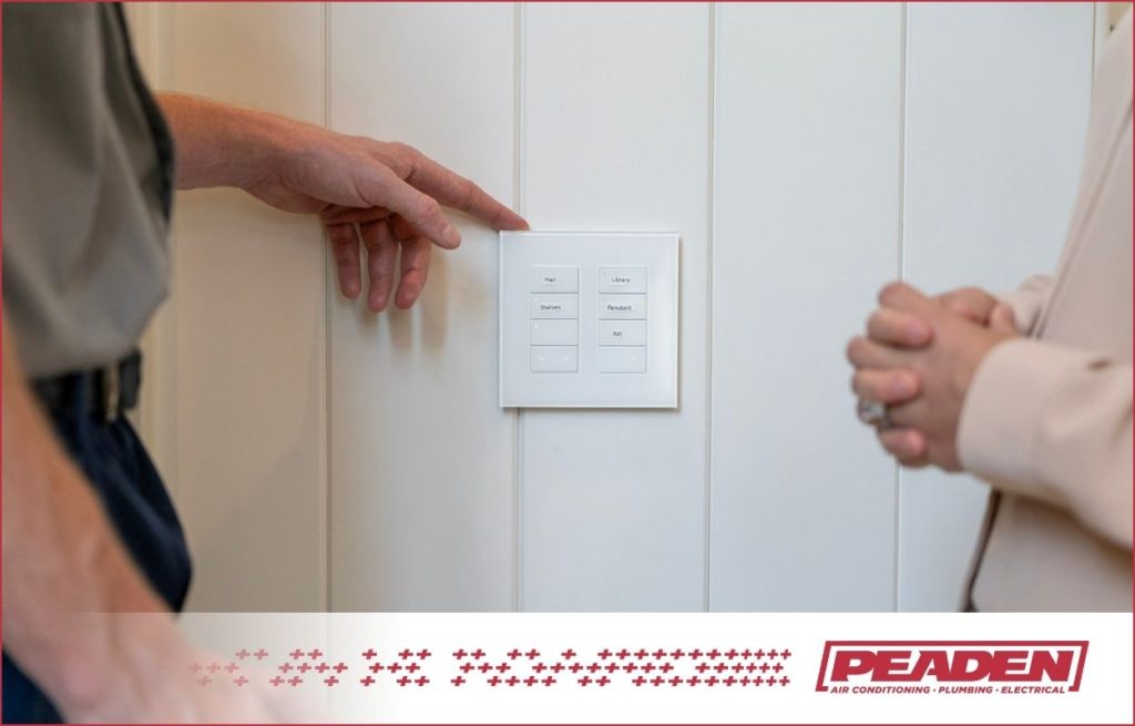 A Peaden Electrician showing the homeowner smart light switches.