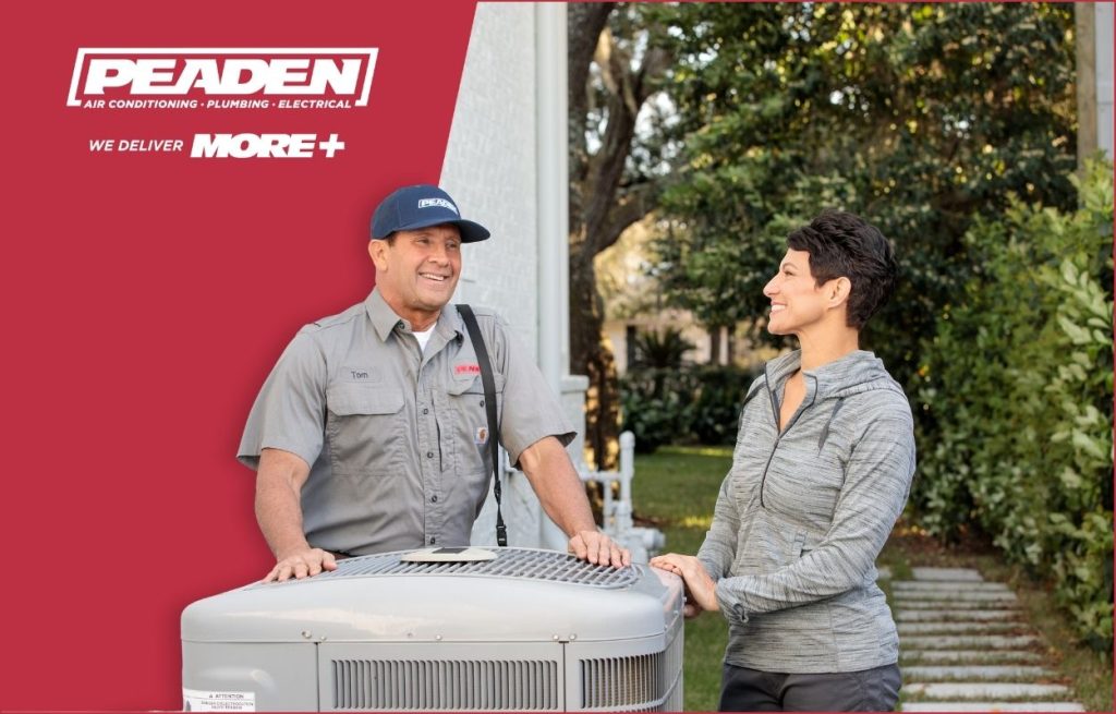 A Peaden HVAC tech showing a new AC unit to a homeowner