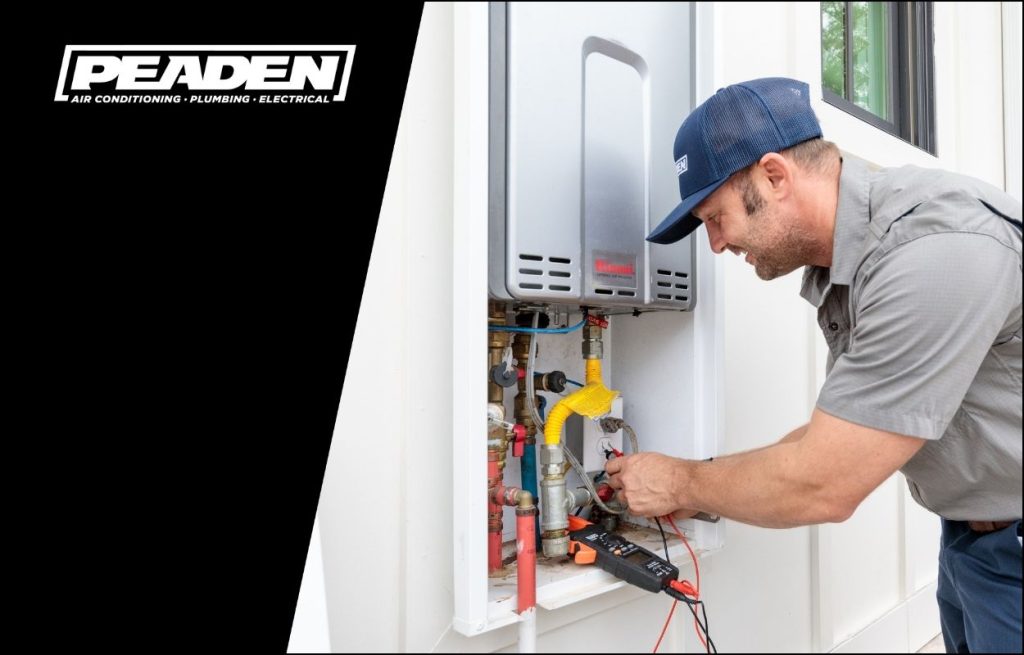 A Peaden plumber servicing a tankless water heater.