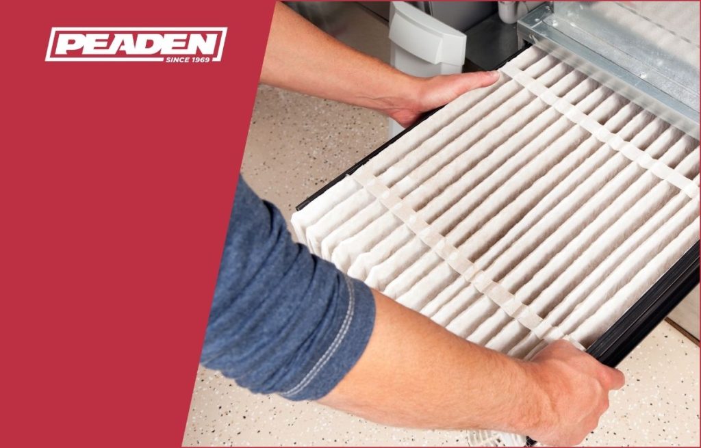 A Peaden HVAC tech changing an air filter