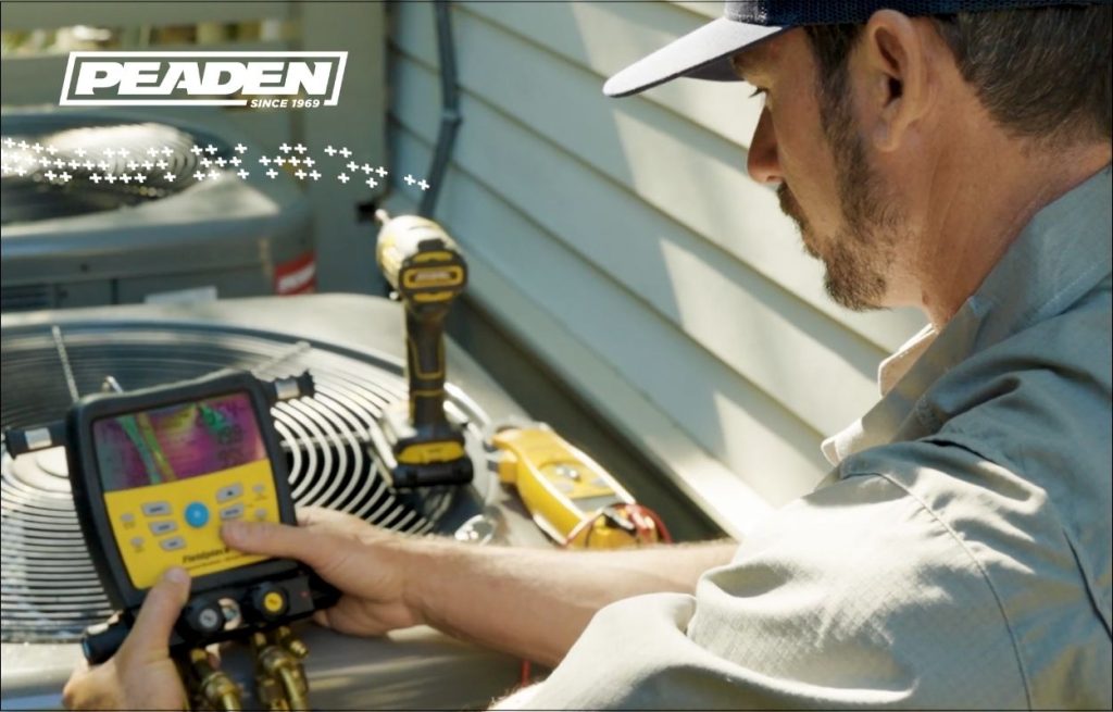 A Peaden HVAC tech servicing an AC unit
