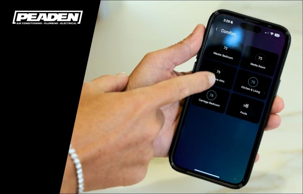A homeowner checking their home HVAC from their phone app.
