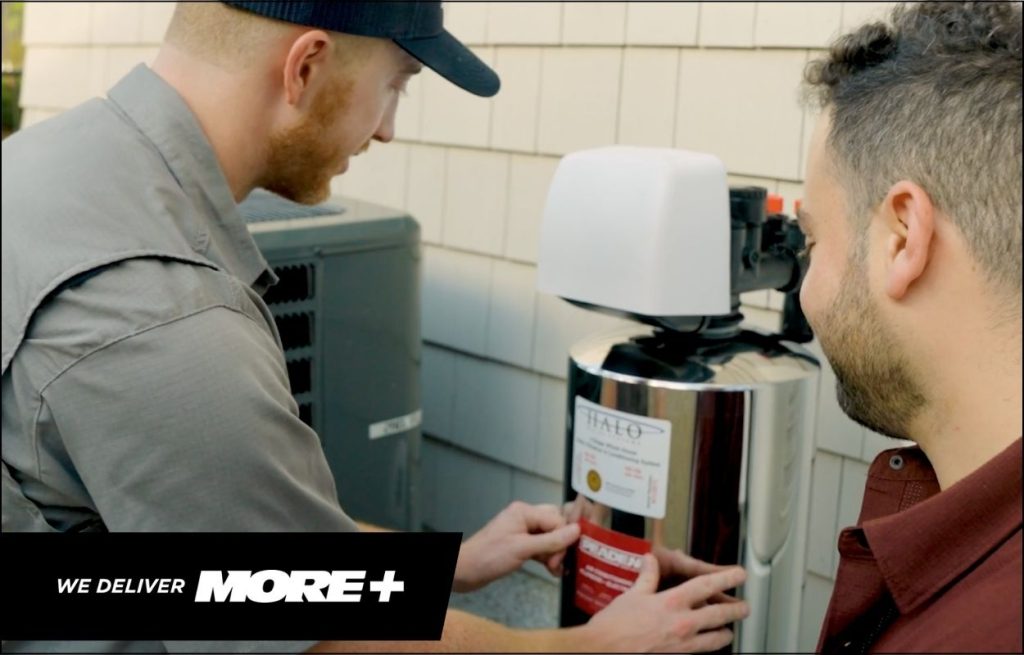 A Peaden plumber explaining water filtration to a client.