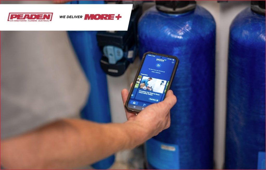 A Peaden plumber showing a homeowner a water filtration system.