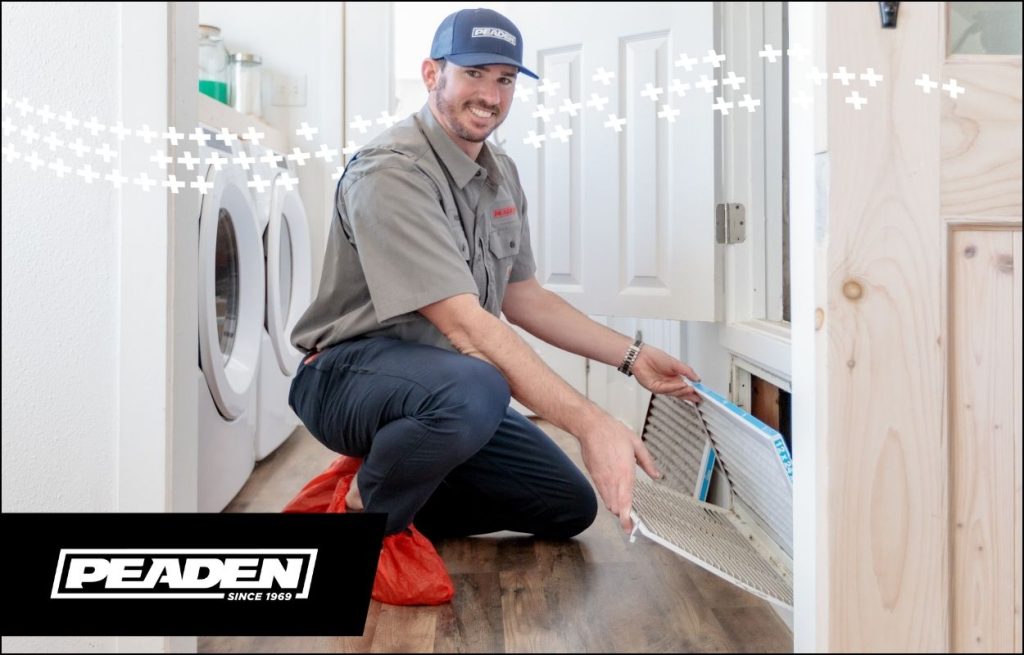 A Peaden HVAC tech changing an air filter